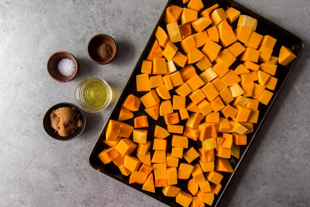 Ingredients to the left of freshly cut squash