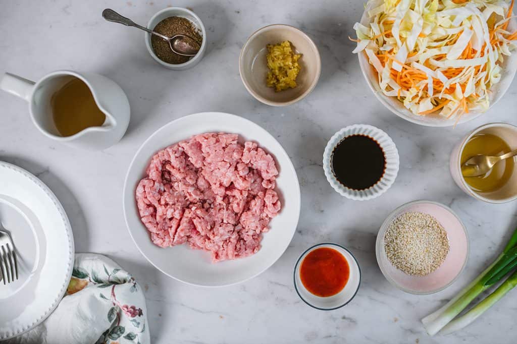 All the ingredients to make egg roll in a bowl inside white ceramic ramekins