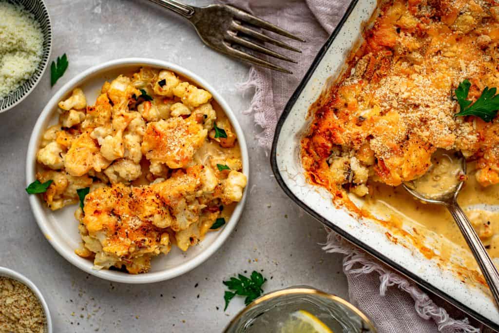 Cauliflower Mac and Cheese serving the completed mac and cheese out of a casserole dish