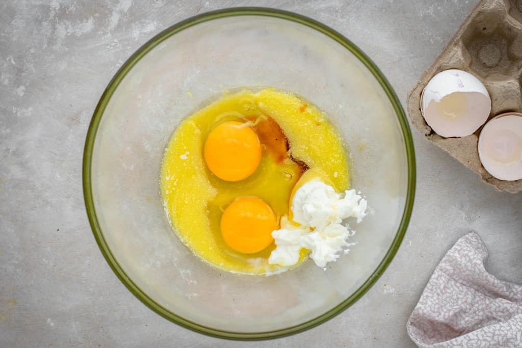 A bowl of wet ingredients after eggs were cracked in.