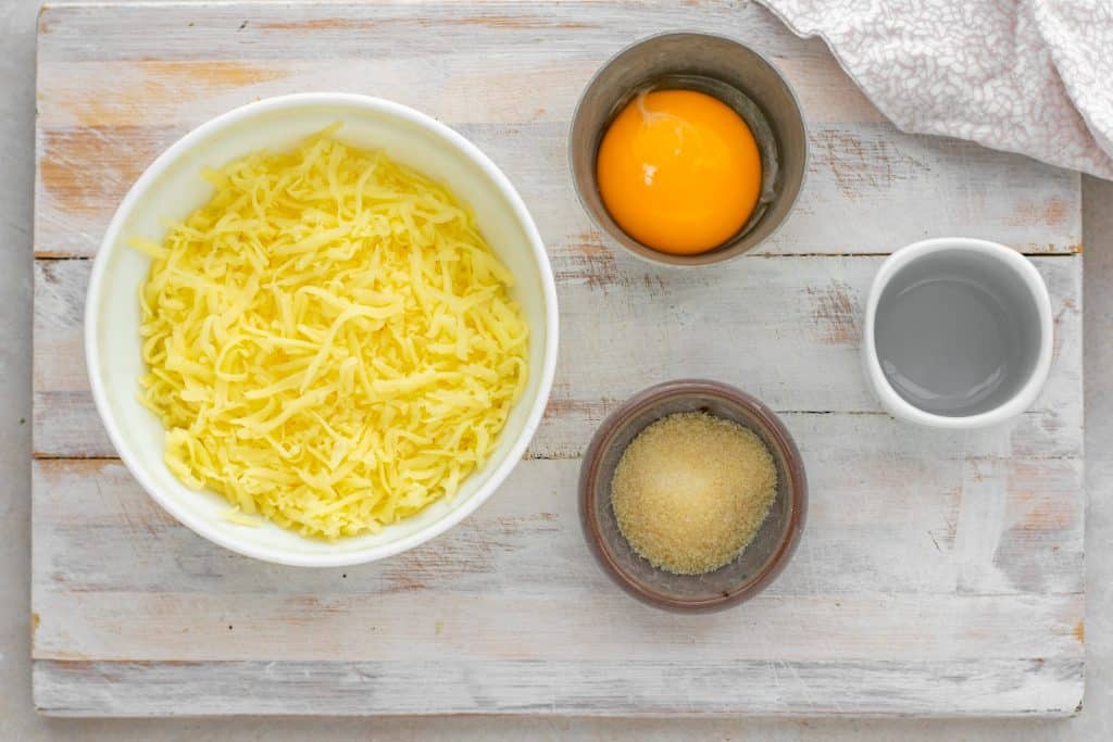 Keto Pasta 4 bowls with the separated ingredients a top a wooden cutting board