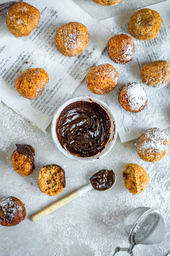 Keto Donuts Finished keto donuts with chocolate in the center and powdered sugar sprinkled all over