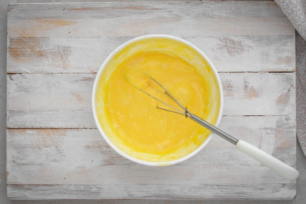 melted cheese combined with the egg yolk using a whisk
