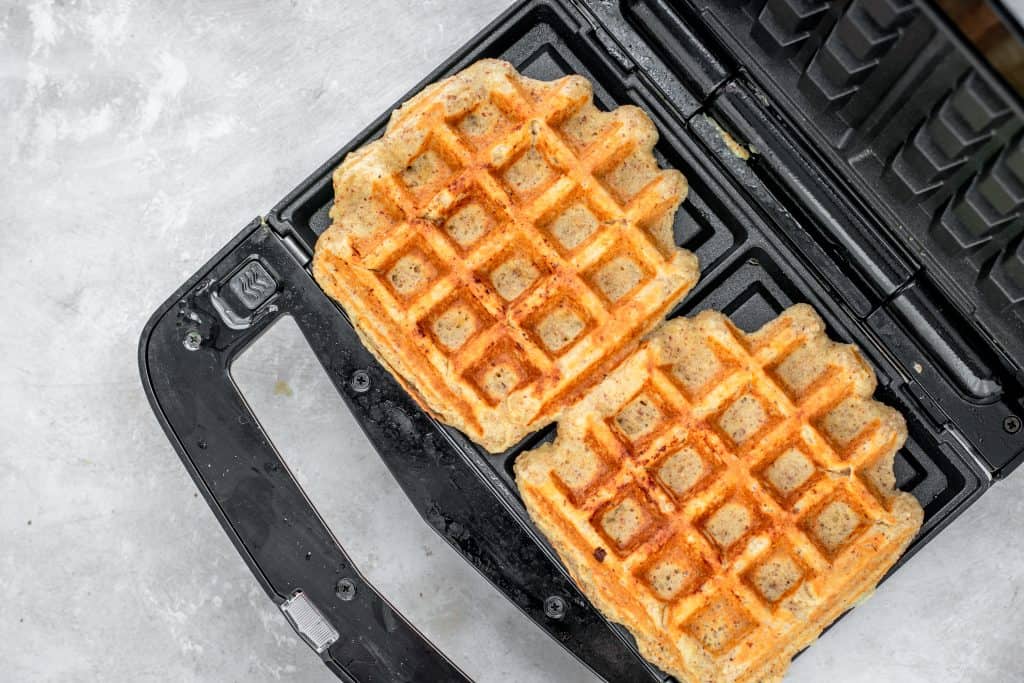 Keto Waffles Golden cooked keto waffles in the waffle iron.