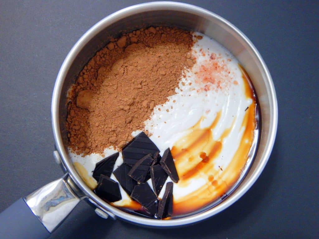 keto hot chocolate coconut milk, chocolate, vanilla, and salt in a silver pot