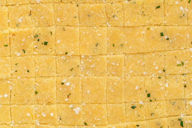 Squares of cheddar crackers cut and then topped with flaky salt. 