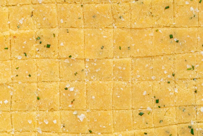 Keto Crackers Squares of cheddar crackers cut and then topped with flaky salt.