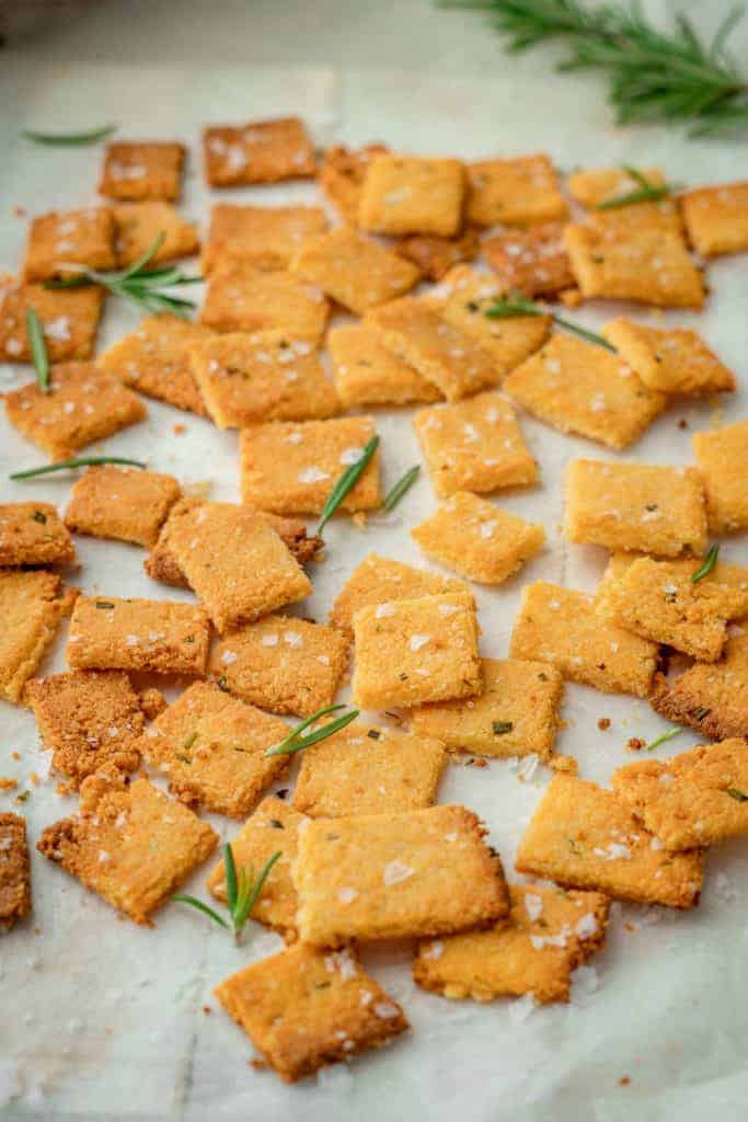 Keto Crackers Baked cheddar crackers with salt and rosemary sprigs