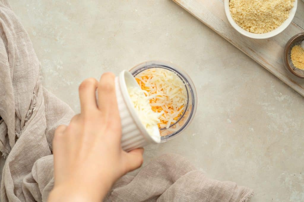 Keto Crackers Putting the cheese into a food processor