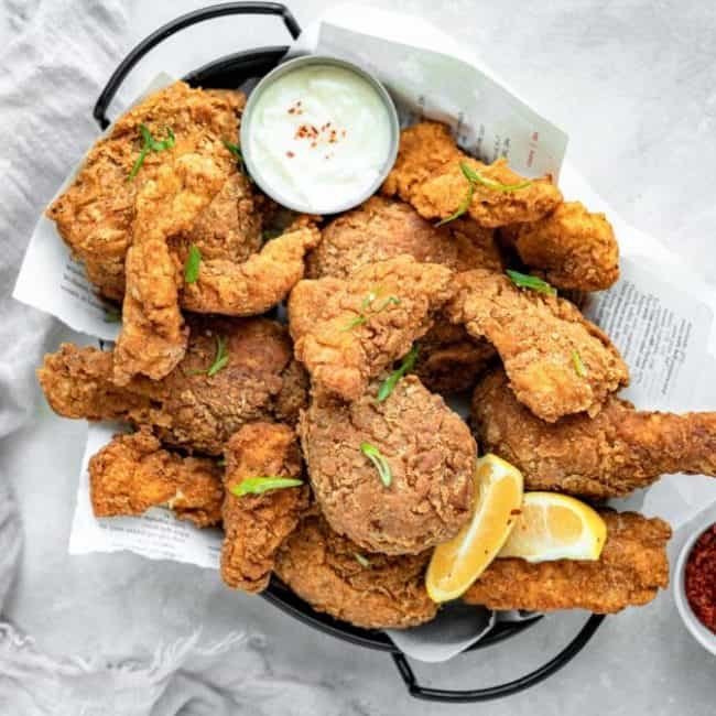 A horizontal shot of finished keto fried chicken in a basket