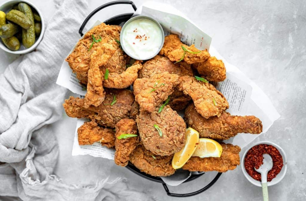 A basket of keto fried chicken next to spices