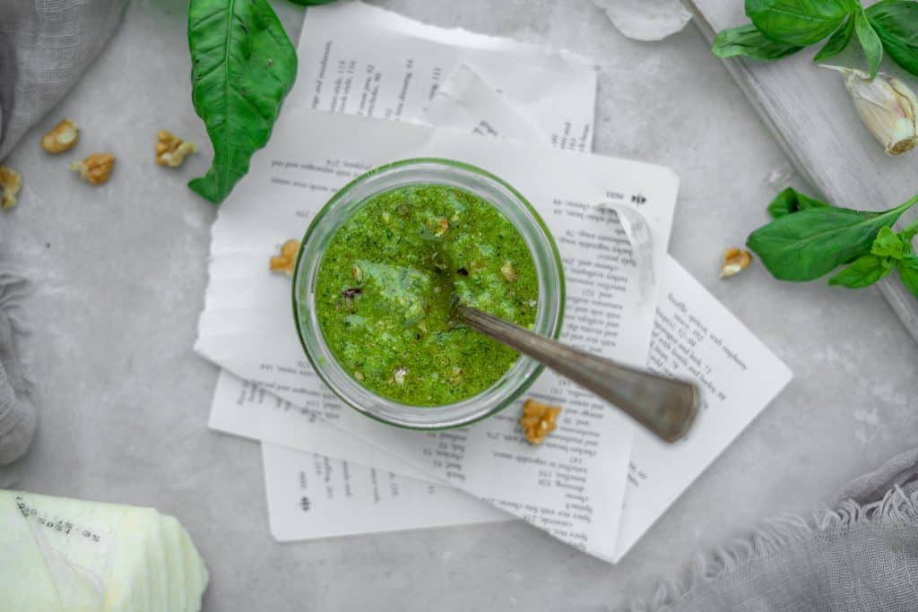 Keto Pesto pesto dish on top of napkins with ingredients around