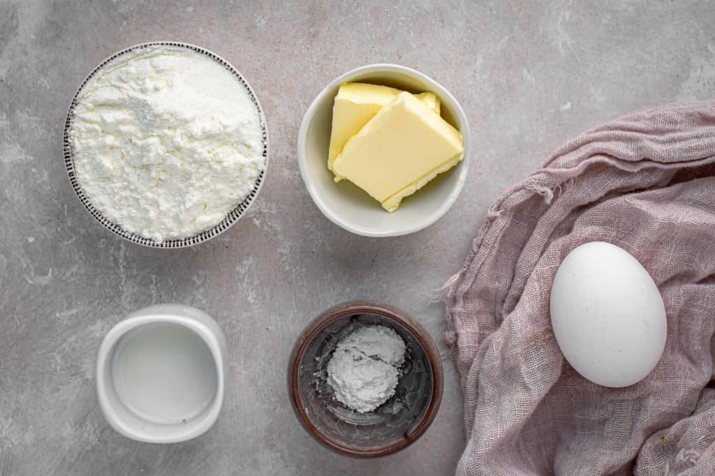 Four small ramekins with the ingredients to make protein waffles