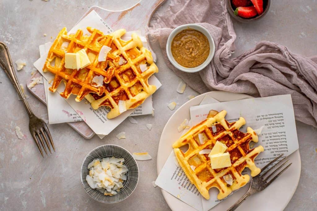 Protein waffles topped with coconut, almond butter, and butter