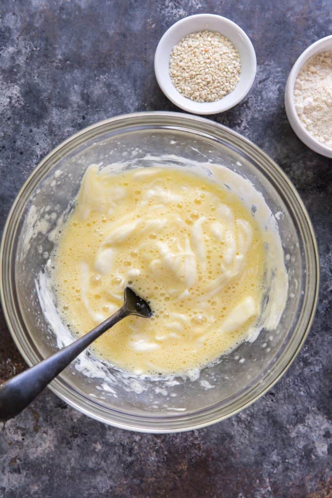 eggs and melted cheese being mixed together