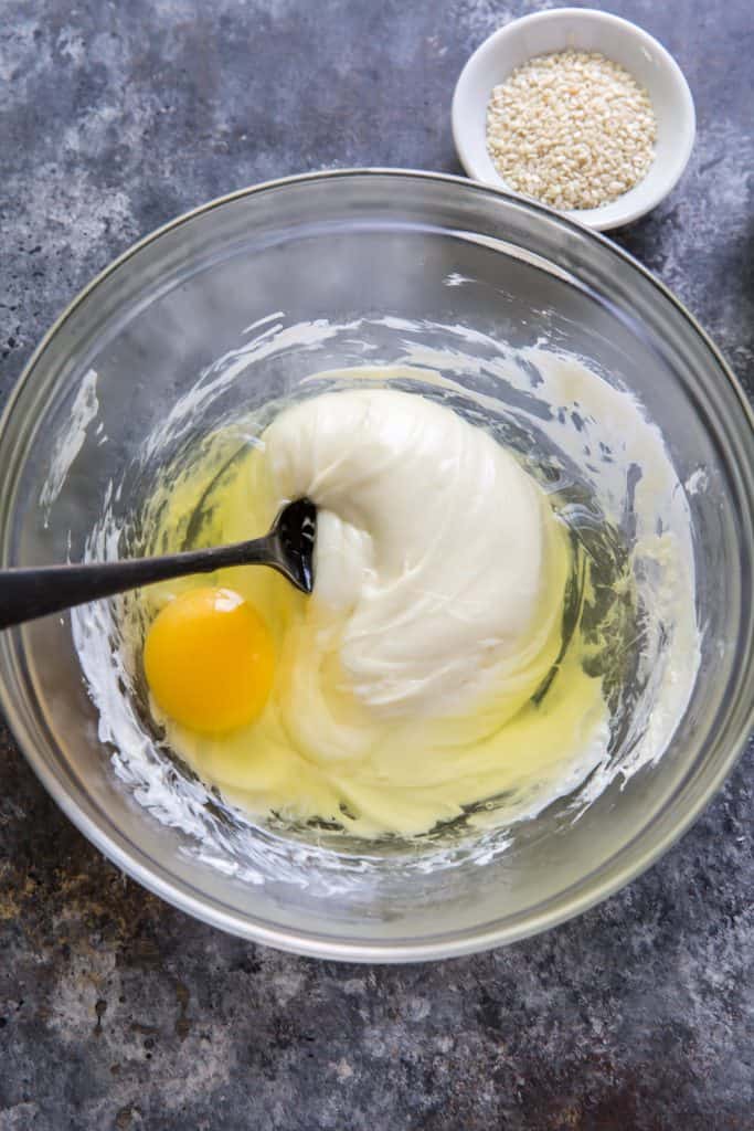 mixing the eggs into the cheese mixture