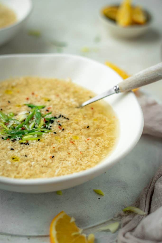 Keto Egg Drop Soup A modern white ceramic bowl with freshly made egg drop soup
