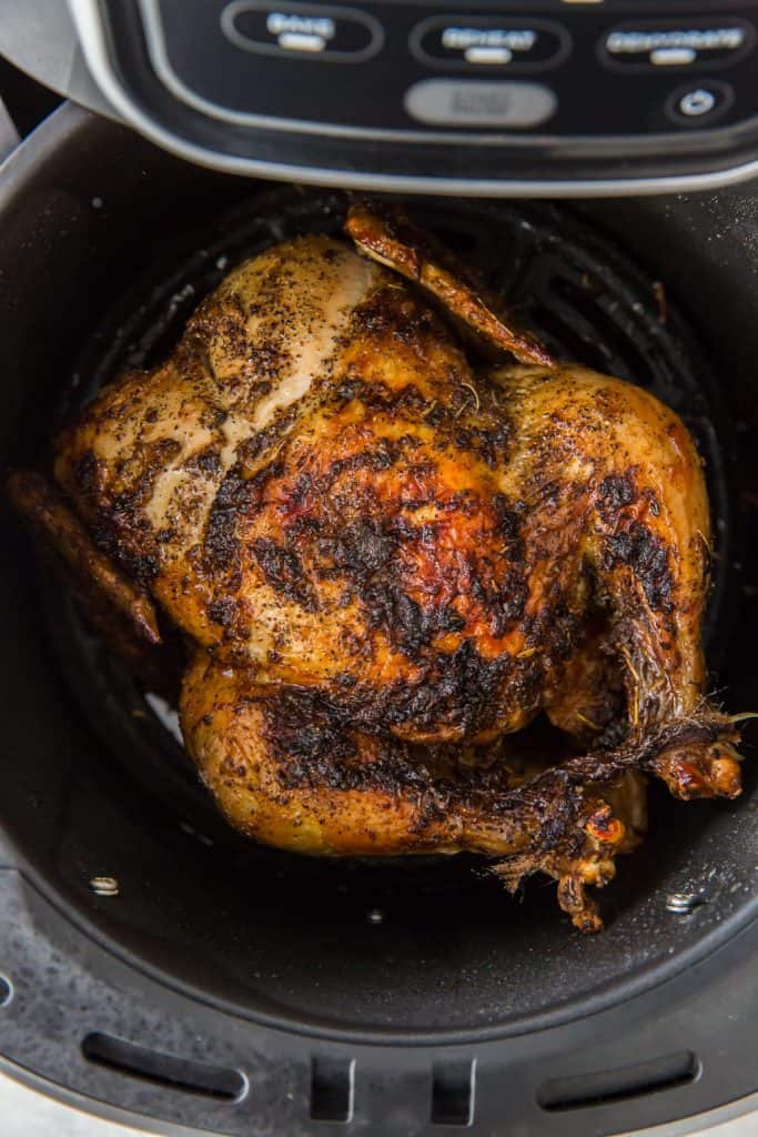 Air Fryer Whole Chicken A whole roasted chicken with its legs tied together