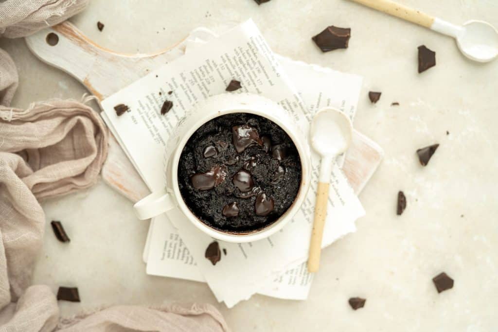 Keto Mug Brownie a white mug filled with dark chocolate and brownie