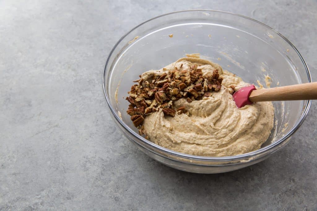 Keto Banana Bread banana bread batter with a handful of pecans folded together
