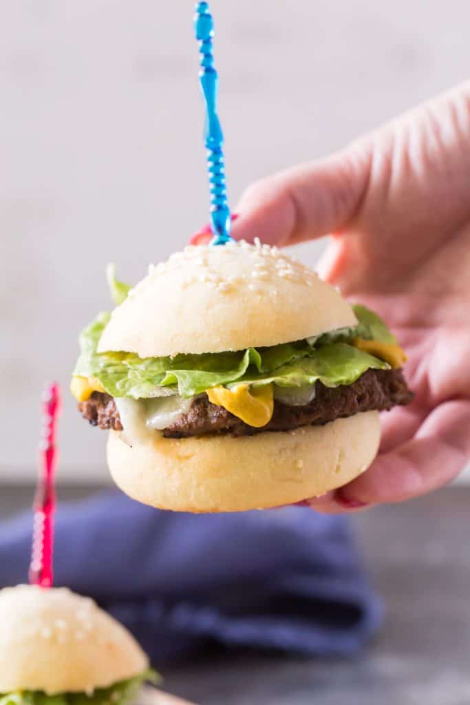 Keto Hamburger Buns a hand holding a mini keto hamburger