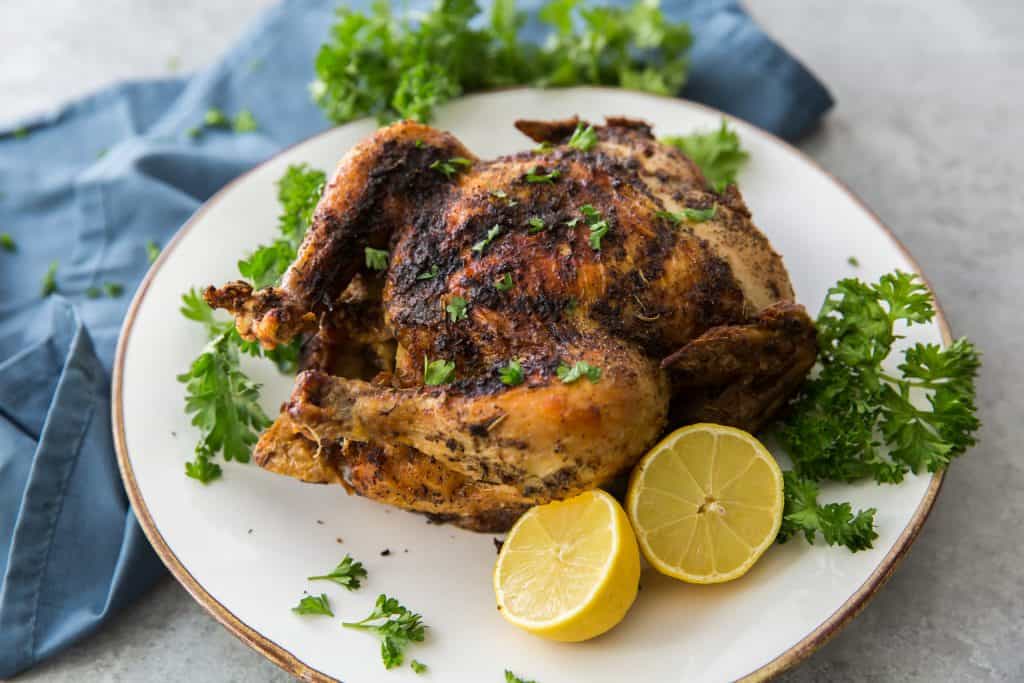 Whole air fried chicken with lemons and parsley 