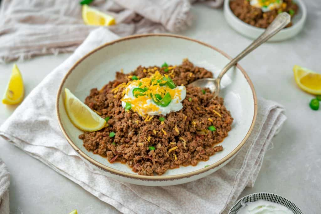 Keto Chili A gray bowl with chili and an antique silver spoon