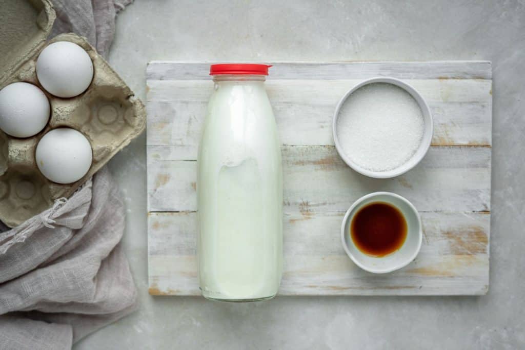Keto Custard ingredients for keto custard on a white wooden board