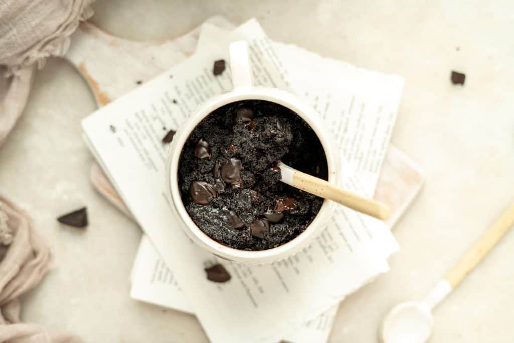 Keto Mug Brownie a moist and fudgy keto brownie being eaten with a spoon