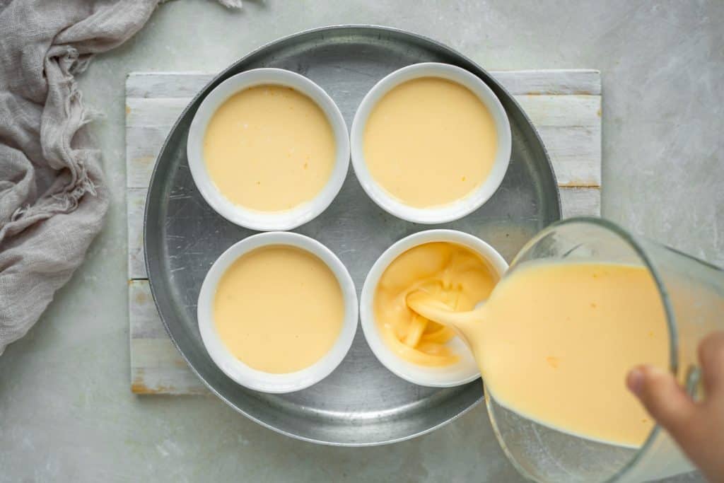 Pouring custard into ramekins