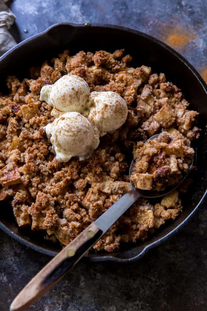 a serving spoon digging into the apple crisp