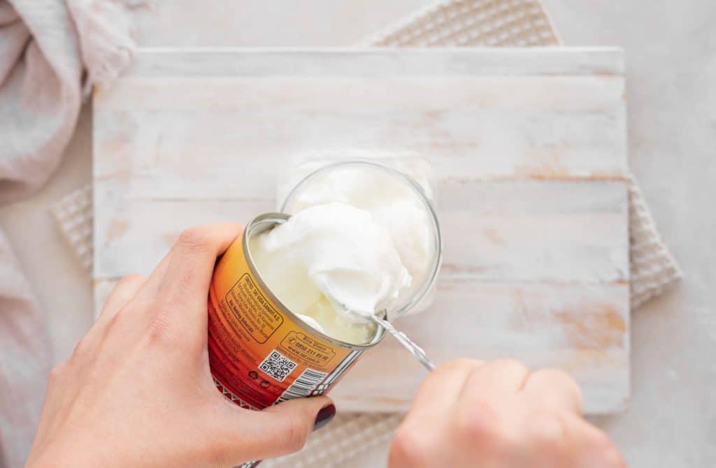 Keto Yogurt Adding coconut cream into a jar