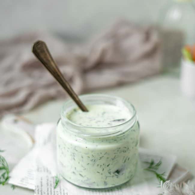 Keto Ranch Dressing A spoon resting in the finished keto ranch