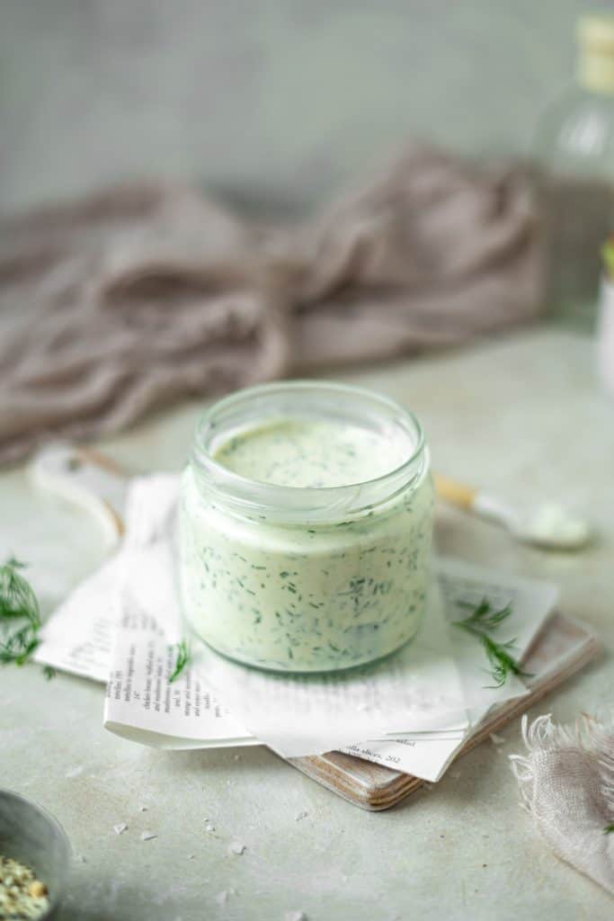 A small glass mason jar with ranch