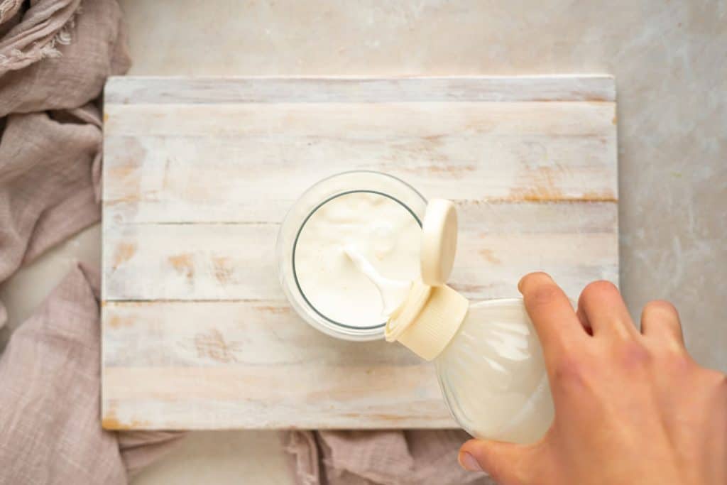 Almond milk added into glass