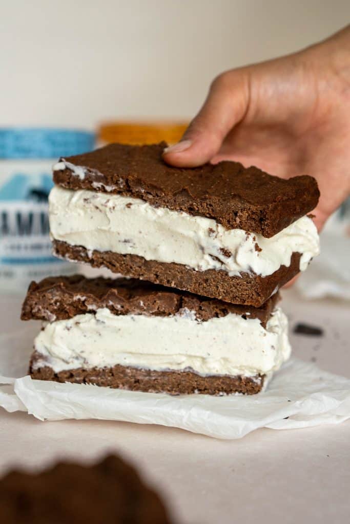 Keto Ice Cream Sandwich hand placing a second ice cream sandwich on top of the first