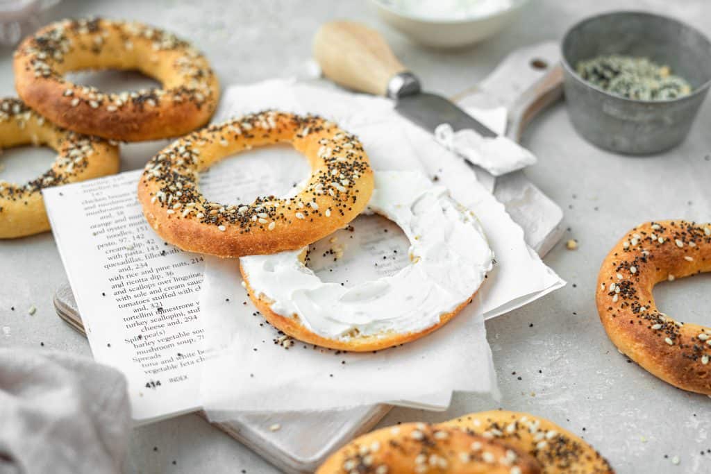 cream cheese on a keto bagel that is fresh out of the oven