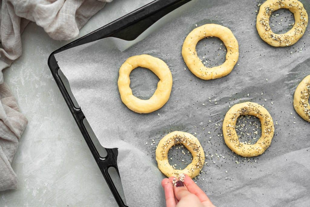 keto bagels adding the everything bagel seasoning to the bagels before placing them in the oven