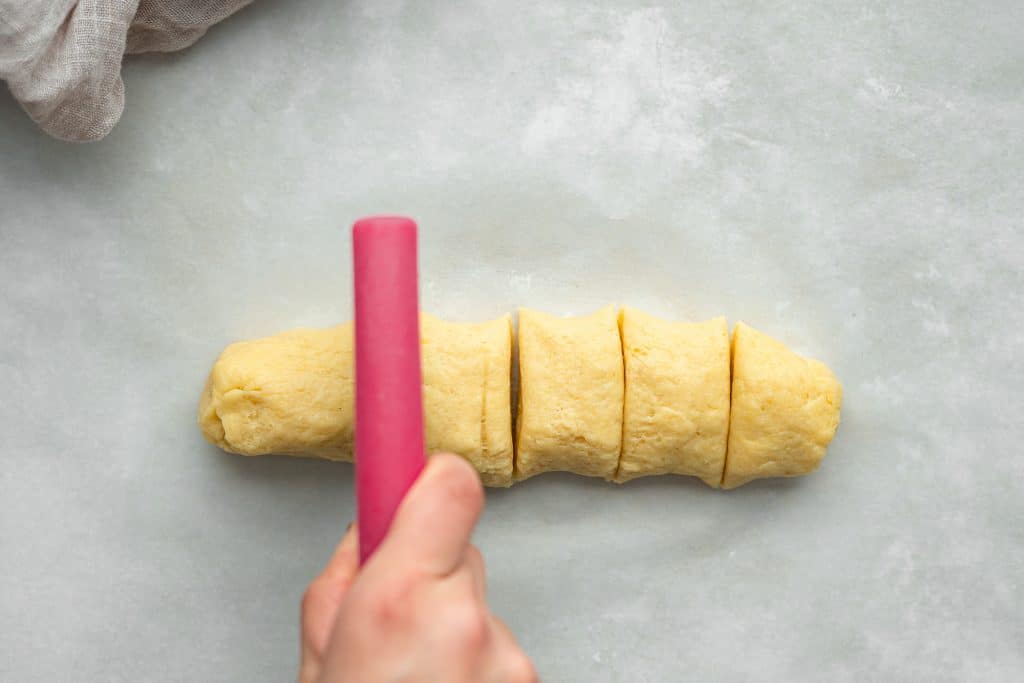 cutting the dough into equal portions before forming into rings