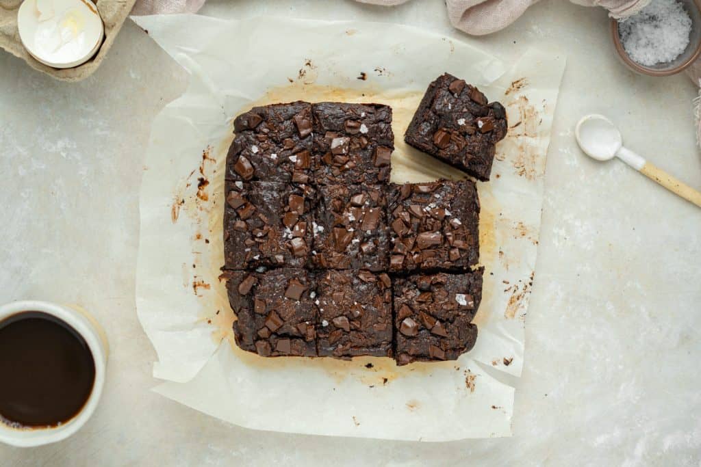 Baked and sliced avocado brownies on parchment paper