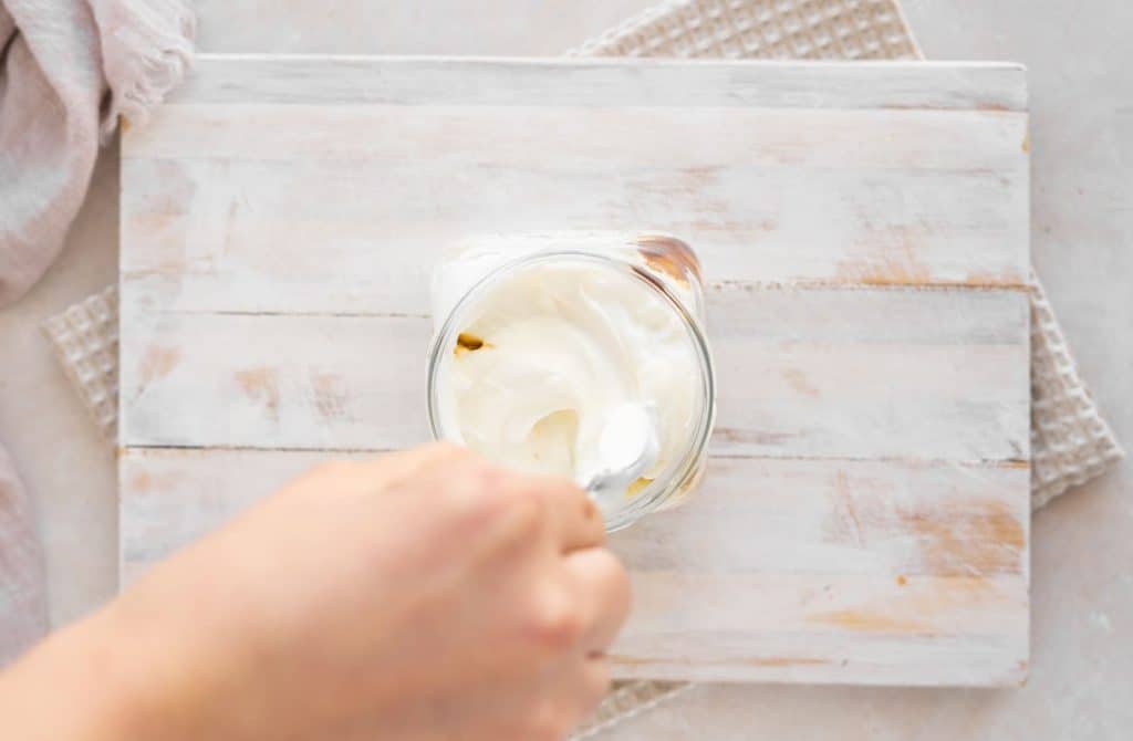 Keto Yogurt Stirring keto yogurt with probiotic