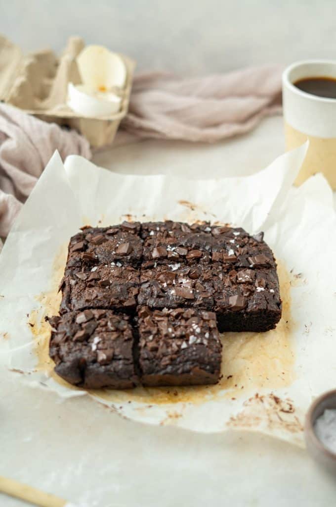 Parchment paper with baked a sliced avocado brownies