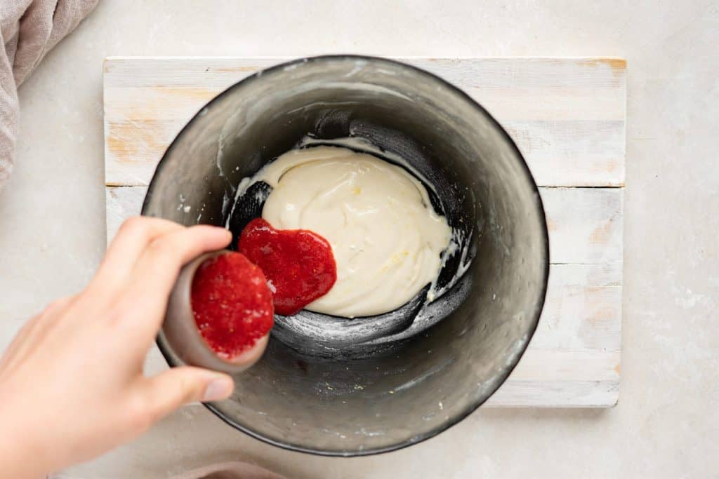 Keto Cheesecake Fat Bombs Strawberry puree in the cheesecake mixture