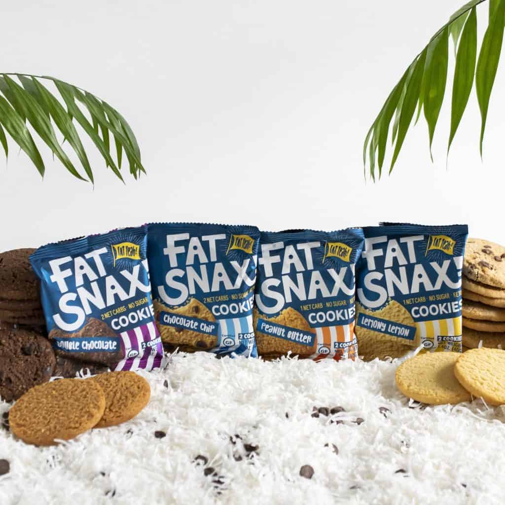 Individual package of all four Fat Snax cookies with a bedding of coconut and chocolate chips