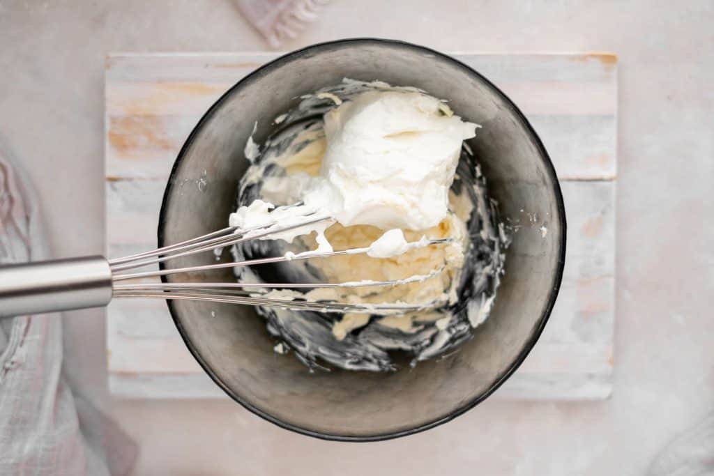 Keto Cheesecake Fat Bombs Mixing cream cheese and butter in a bowl
