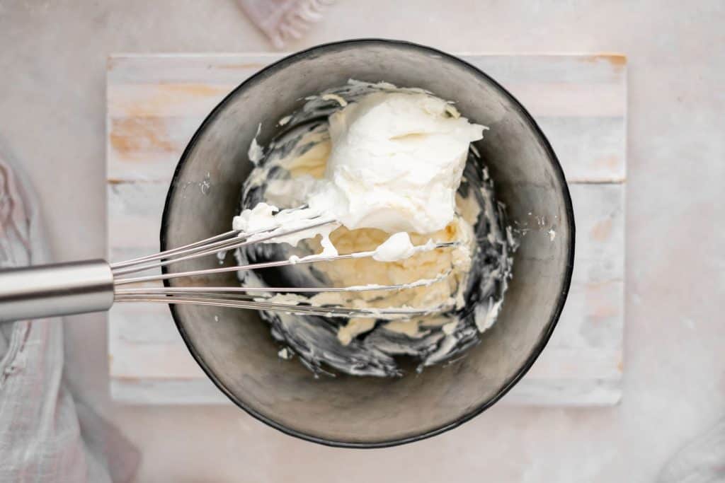 Mixing cream cheese and butter in a bowl