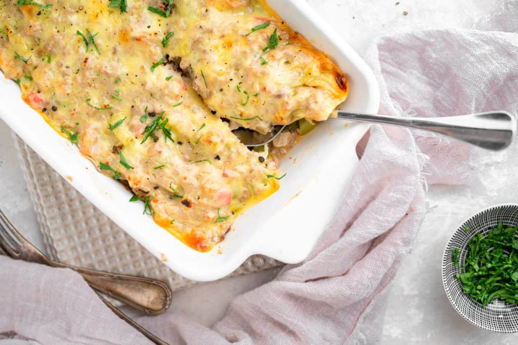 Philly cheesesteak casserole A white ceramic baking dish filled with casserole