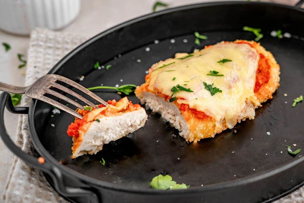 keto chicken parmesan finished keto chicken parmesan recipe with a bite taken out
