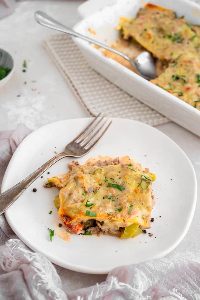 Philly cheesesteak casserole A corner piece of casserole with a silver fork