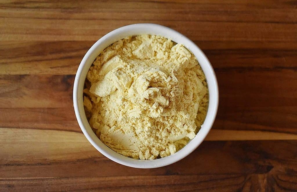 Overhead view of ground lupin flour in a white bowl.